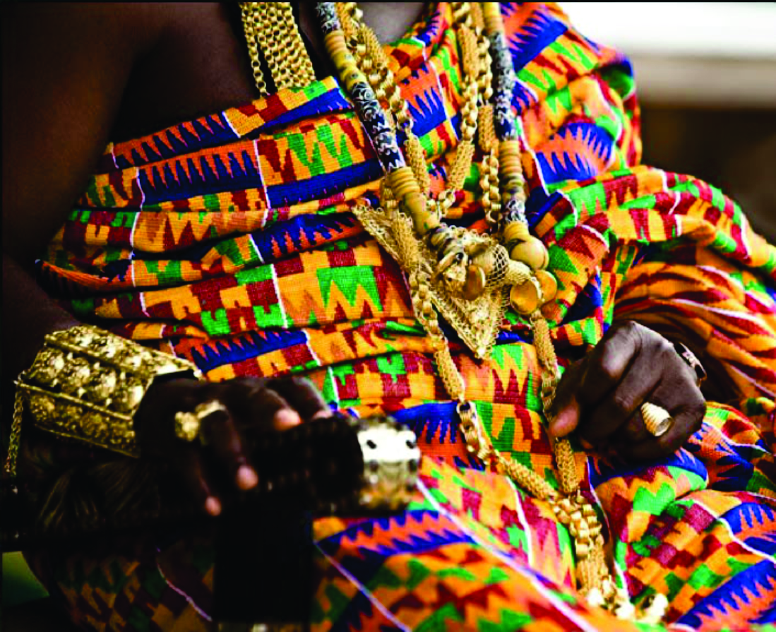 Colourful Ghanaian kente regalia and layered gold jewellery